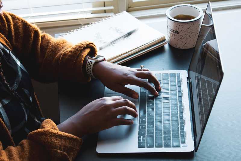 person typing on laptop