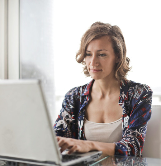 A woman working at a laptop. 